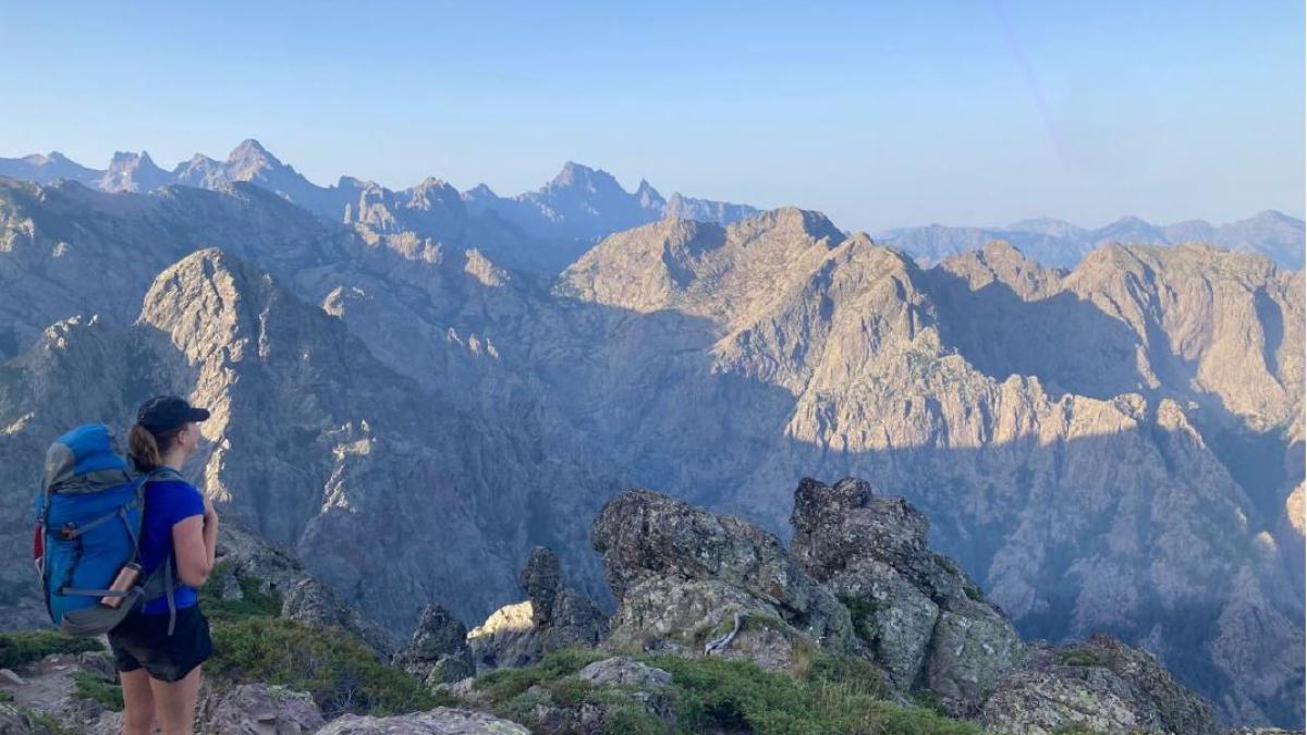 Student standing in mountains