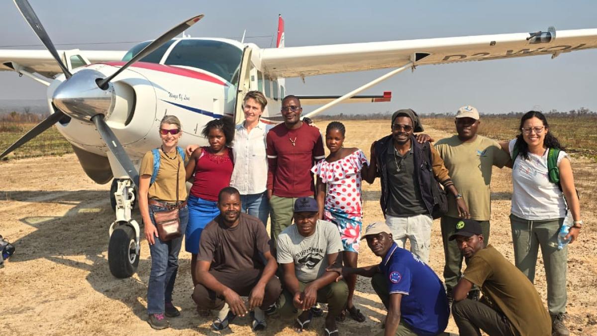 Students in front of plane in desert