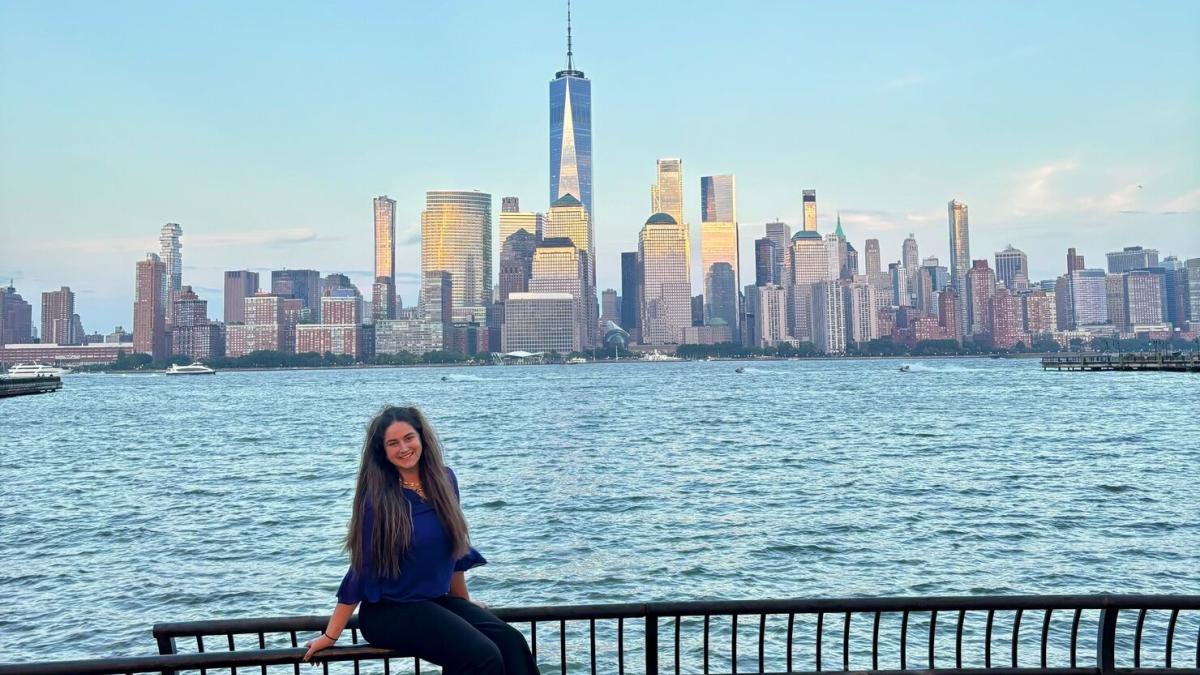 Student sitting in front of New York City skyline