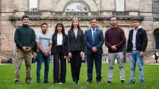 Seven people from Education Beyond Borders standing outside of the University's Old College.