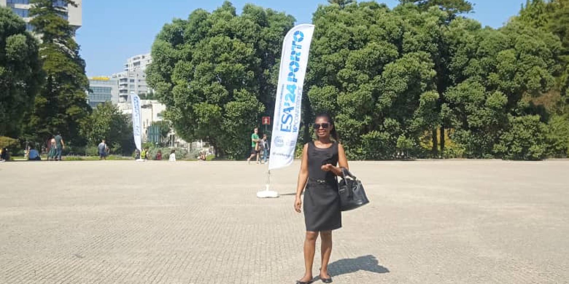 Student standing in front of conference building