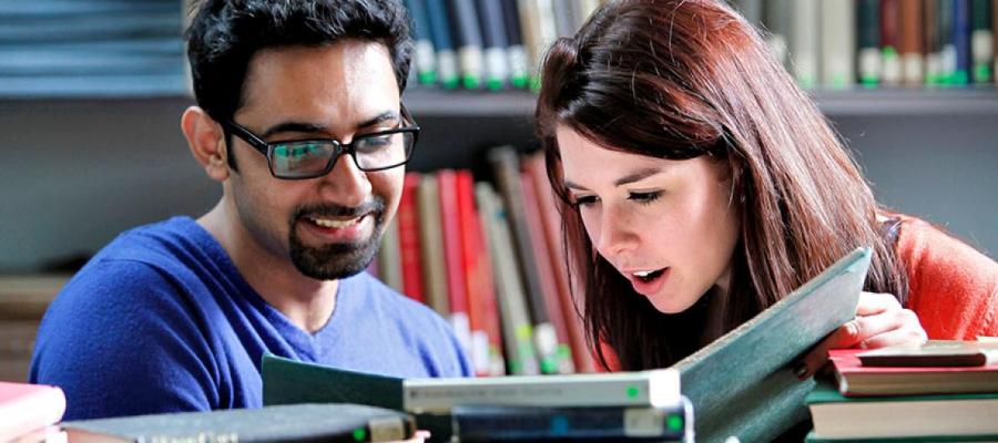 Students converse in the library 