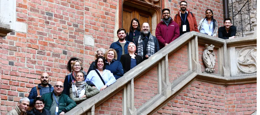 Staff week participants on a staircase in Krakow
