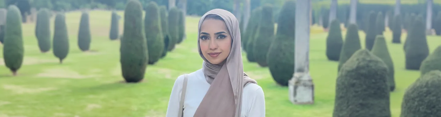 Portrait image of Afraa outside in beautiful gardens