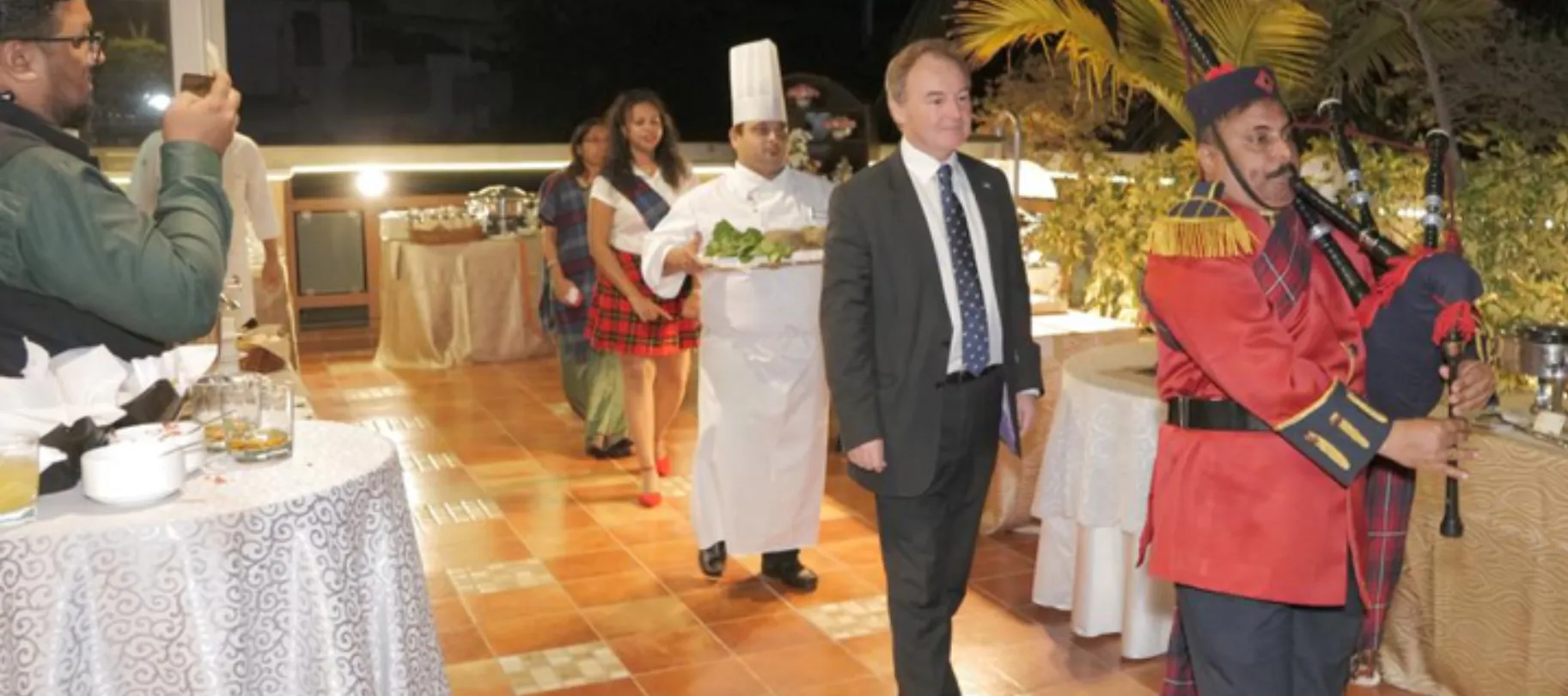 Jeremy Pilmore-Bedford walks behind as the haggis is piped