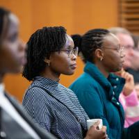 Audience members listening