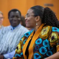 Audience members listening