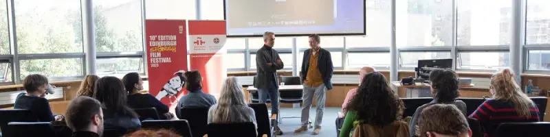 Two people discussing a film in front of an audience at the Edinburgh Spanish film festival 