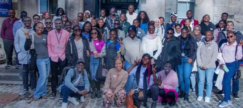 A large group of people posing and smiling for the camera.
