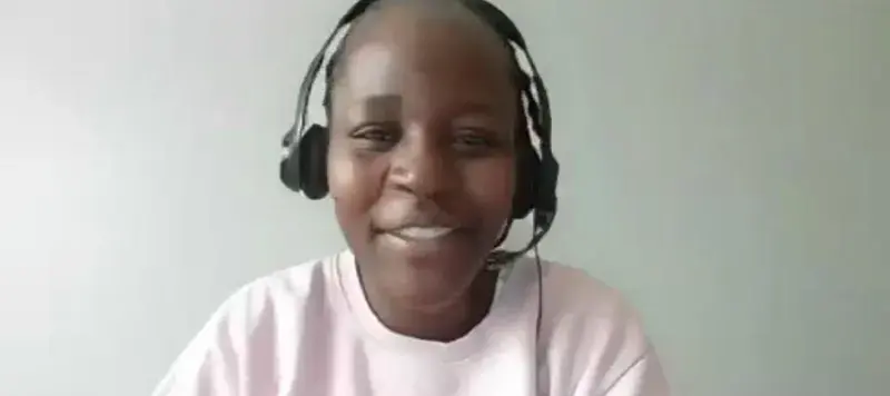 A screenshot from a video call, showing Phenny Omondi speaking to the camera.