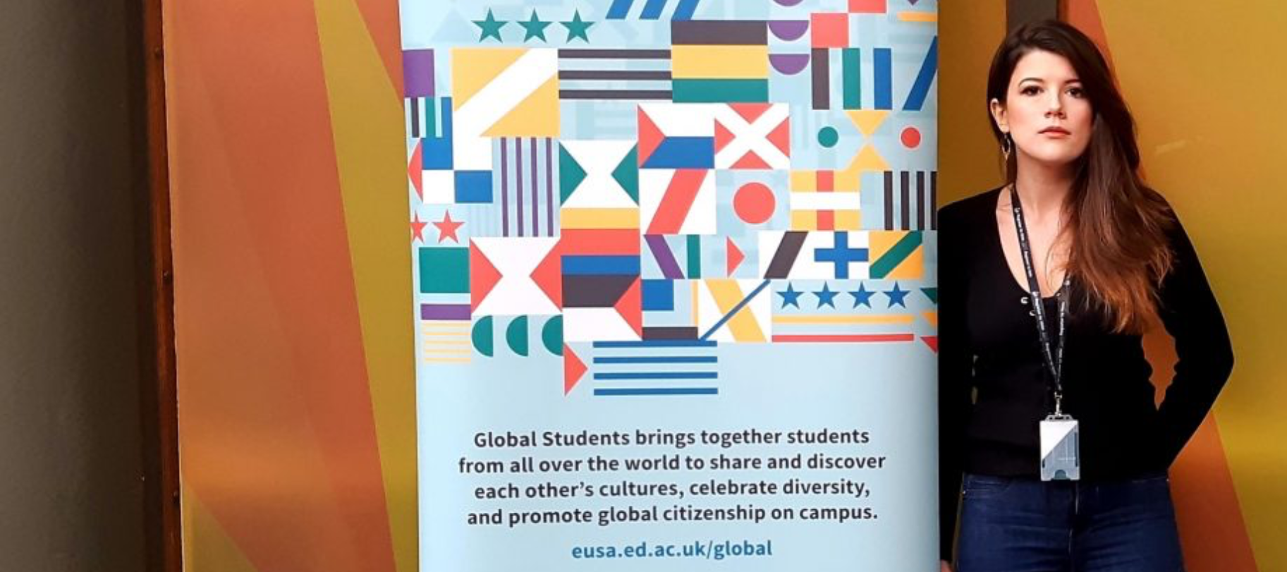 Laura Jimenez in front of banner