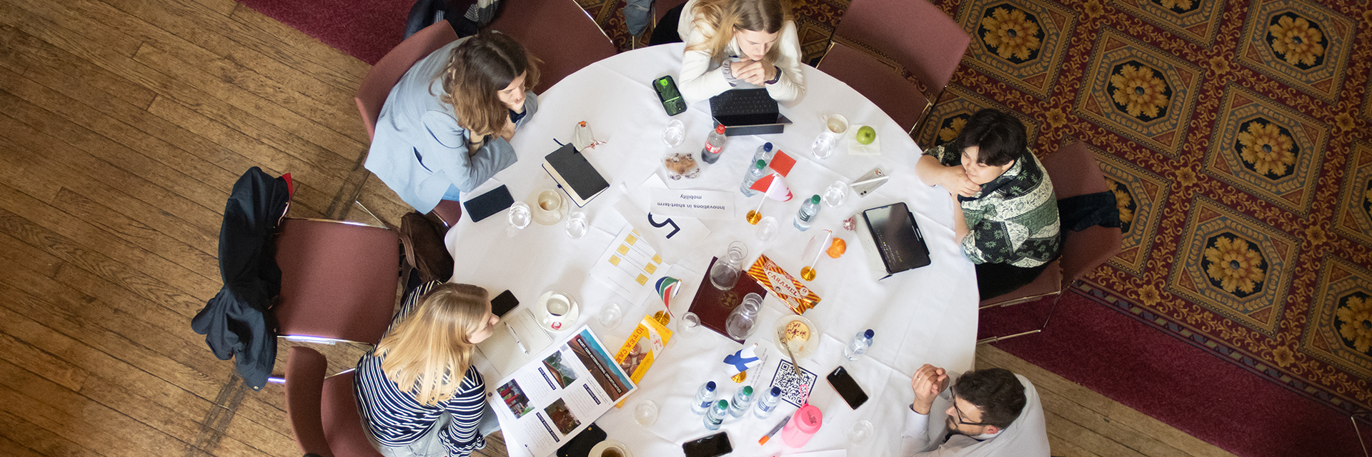 Overhead people speaking at round table