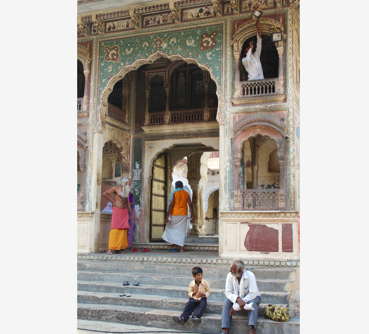 people sitting on steps of a temple