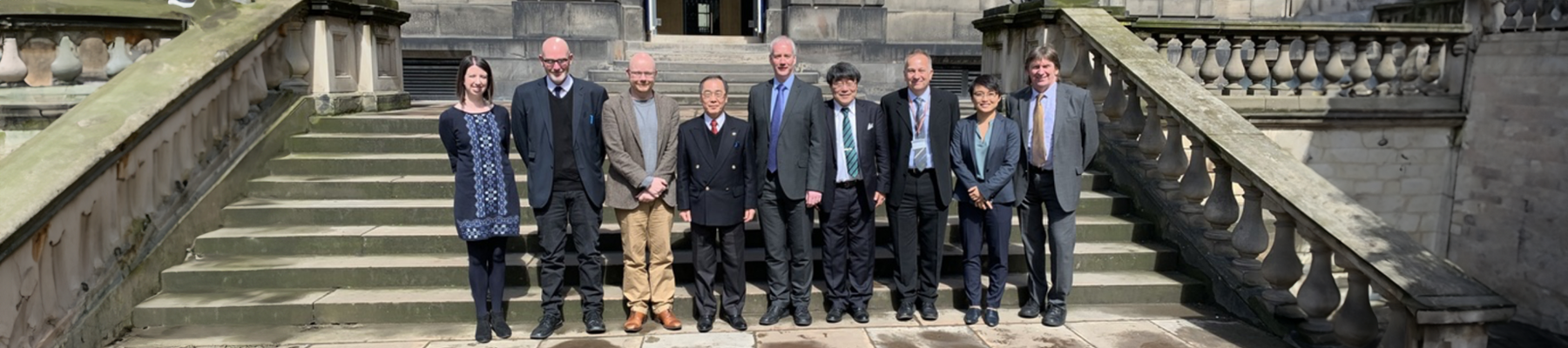 Edinburgh Global colleagues standing outside Old College with colleague from Nagoya University