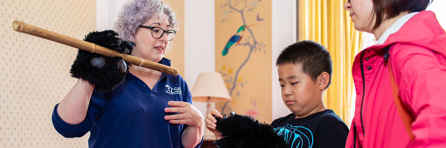 Showing young boy how panda holds bamboo