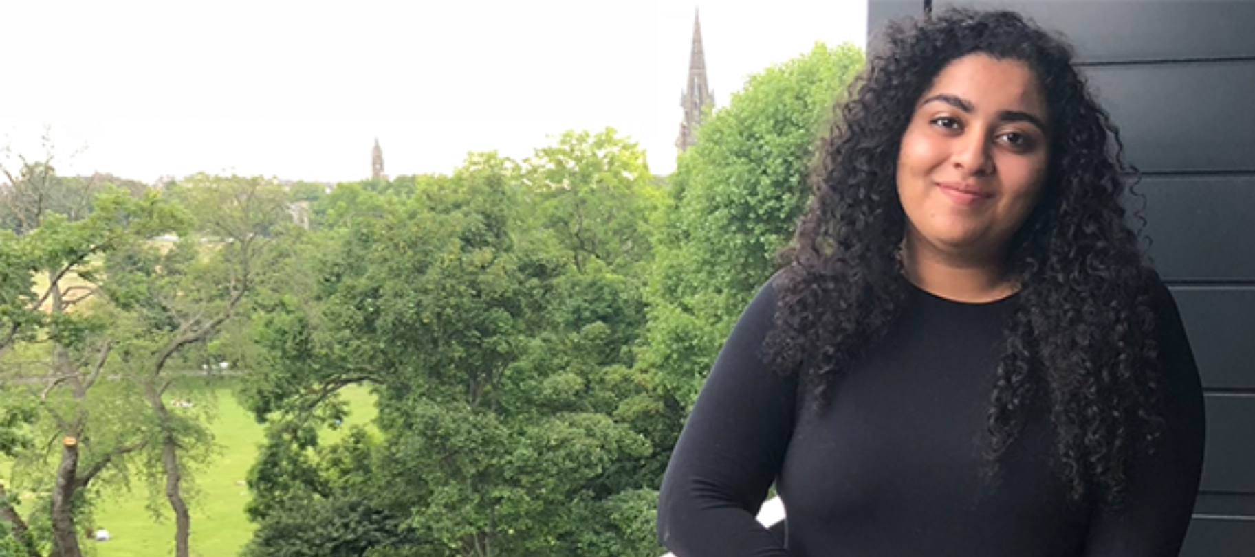 woman smiling above trees