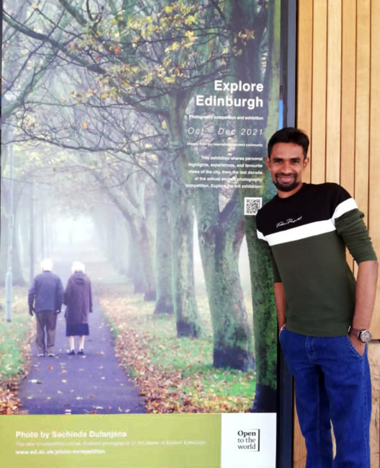 man standing next to banner