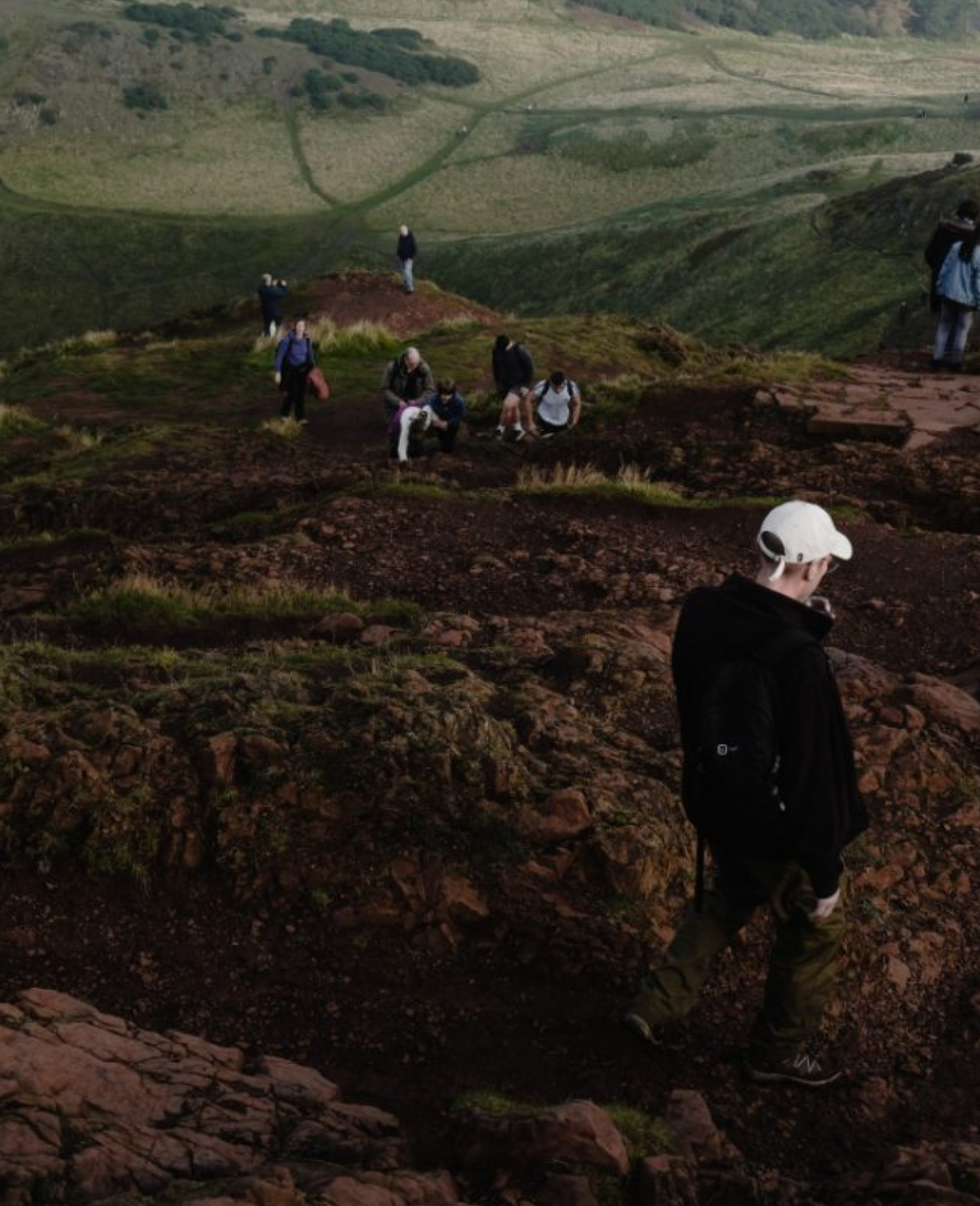 people ascending hillside