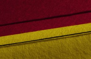 red and yellow fabric with a black thread